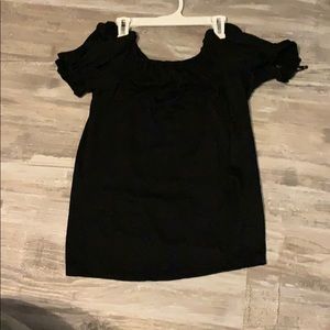 a black off the shoulder shirt/blouse